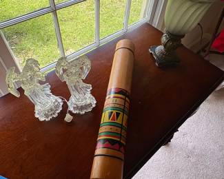 Assorted glass and wood decor—rain stick, lamps, side tables