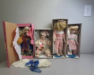 Four Porcelain Dolls in Boxes