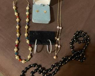 Gold, sterling, onyx and pearl tune jewelry at the showcase table