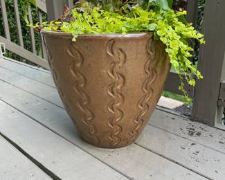 K131 - $65. Ceramic Planter with beautiful curved designs. 14" interior diameter. 15" tall. Unknown plant types included.