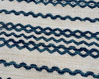 K132 - $250. Brand New! Gorgeous navy and ivory indoor/outdoor rug. Measures 94"x124".