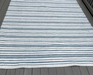 K132 - $250. Brand New! Gorgeous navy and ivory indoor/outdoor rug. Measures 94"x124".