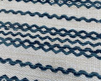 K132 - $250. Brand New! Gorgeous navy and ivory indoor/outdoor rug. Measures 94"x124".