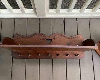 K134 - $20. Carved wood shelf with hanging pegs. 30w12d11t.
