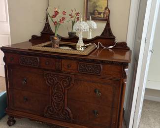 90+ years old bedroom set. Been in the family since purchased new in Chicago. Carved mahogany dresser w/ mirror.