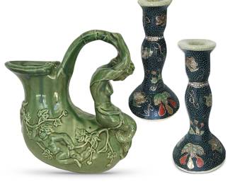 Traditional Asian Arts:  Shi Wan mermaid and cherub pitcher exemplifying hand-crafted nature of this Chinese pottery which is fired with heavy glazes that drip in unique patterns from piece to piece; about 11”H; pair of Japanese hand-painted Royal Satsuma candlesticks with white moriage dot work and gold relief/slip trailing relief; about 9”H
