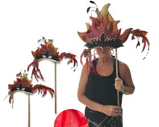 Pair of vintage firebird or phoenix styled masks from estate of former FELD/circus employee; 35"H x 15"W.   A recent owner of the masks believes they may have been used in a Disney on Ice or circus production. Written on the cloth lining is "Stop Drop and Roll," as if they may have been part of a fire safety skit.