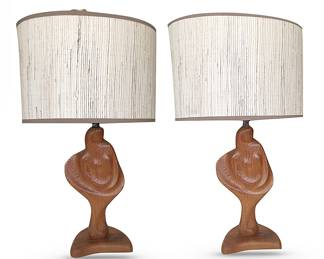 Two rare and highly sought after abstract female figure Yasha Heifetz lamps w/original shades; 30” H.  Heifetz — not to be confused with the violinist — was a designer and artist who founded the Manhattan Heifetz Manufacturing Company in 1938. He was a major contributor to mid-century lighting design.  In 1950, MOMA selected ten of his lamps for exhibition and production.  The Heifetz female figure lamps are considered collector's items.  
