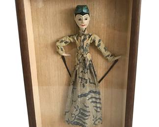 Indonesian Wayang Golek (shadow/Wood) puppet* in glass display case; puppet wears cotton batik clothing and traditional headdress; possibly represents a court dancer; framed 19”H x 14”W (NOTE: Sets sold in pairs of male and female puppets identify this figure as male.)