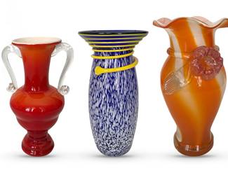 Three mid-century art glass vases.  L to R:  Roman red amphora-style vase, likely Italian, 10”H; speckled  cobalt and white vase (Kosta Boda?) with yellow applied spiral, 11”H; orange fluted neck vase with applied florals, 12”H