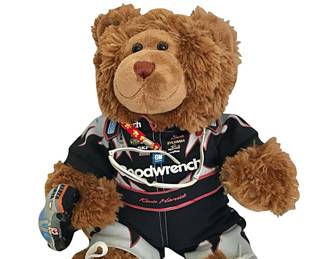 Plush bear representing a pit stop member of racing star Kevin Harvick’s  RCR/NASCAR sponsor, "Team Goodwrench”; holds mini version of Kevin’s #29 GM/Goodwrench Service Plus Chevrolet race car; wears Goodwrench service suit and has cool sunglasses hanging from his neck; one of the more elaborately outfitted pit stop bears we have seen, right down to his high-top sneakers; bear possibly by Build-a-Bear; 18”H