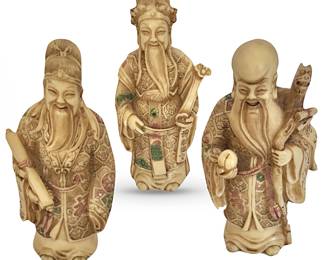 Trio of 6-7”H resin figures representing  happy Chinese Star Gods.  L to R:  Fu holding his scroll of ongoing good fortune; Lu holding his Ruyi scepter representing authority and well wishes; Shou Lao, holding a peach recalling Chinese legend of celestial Peaches of Immortality, and also holding dragon-headed staff associated with  power and good fortune