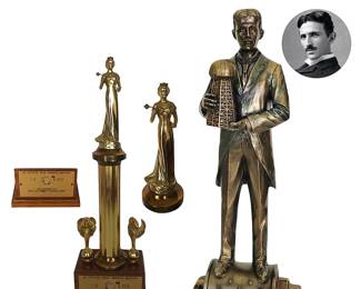Desk/den décor, L to R:  1969 Lee County (FL) official Miss America pageant trophy, Miss America seal missing from plaque and some pocking on column support, but statuette looks good; cold cast antique bronzed resin statue of Nikola Tesla (1856 - 1943) holding model of Wardenclyffe Tower, also known as Tesla Tower, and standing atop one of his original alternating current induction motors; 12”H