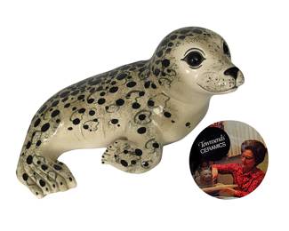 Much sought after signed Townsends’ Ceramics seal pup; 8"H x 18-19”L.  Alaskan-born artist Ann Townsend and her family opened Townsend Ceramics & Glass, Inc. in Titusville, FL in 1969.  For 35 years the company produced animal figurines that have become highly prized for their hand-painted finishes, lifelike appearances and shiny glazed surfaces. Every mold was designed by Ann who also finished many of the works.