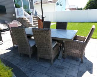Peter Andrews outdoor dining table with 6 wicker high back chairs & umbrella