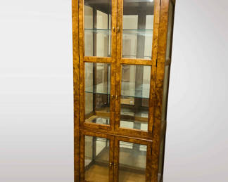 Vintage burled walnut display cabinet. Burled walnut furniture gained popularity during the 18th and 19th centuries, prized for its unique and decorative grain patterns. The use of burled wood, which comes from abnormal growths on trees, adds a distinctive character to furniture pieces. These growths create swirling, intricate patterns