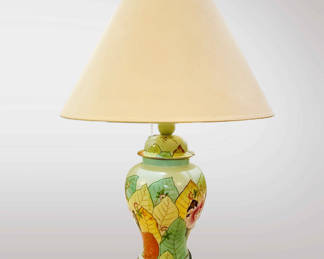 Vintage ginger jar lamp with a hand-painted leaf design. The lamp appears to be a ginger jar lamp, which is a style that gained popularity in the 20th century, particularly during the mid-century modern era. These lamps often feature a ceramic or porcelain base shaped like a traditional Chinese ginger jar, known for its rounded body and short neck.