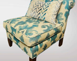 Slipper chair with a turquoise ikat pattern.