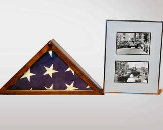 This is a memorial flag display case with accompanying photographs.