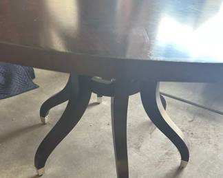 Round Dining Table that includes a center leaf to create an oval.