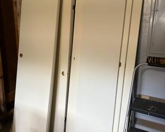 Brand new wood doors homeowner bought to install at this home but he never got around to it before the home sold.   These are “midcentury” style doors to match the three original doors in this house.   