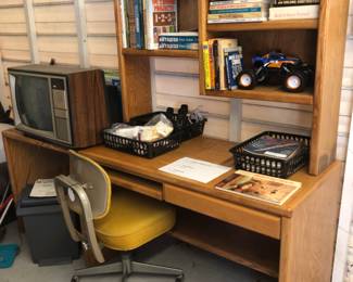 Desk and chair.  Books, old tv.
