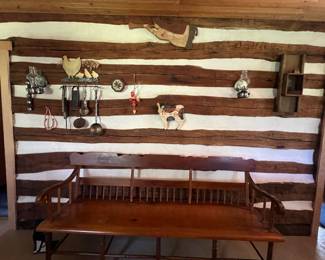 Wall of vintage and antique folk art decor. Custom antique long bench