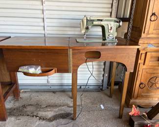 Lot 107- New Home Sewing Machine attached to a Table