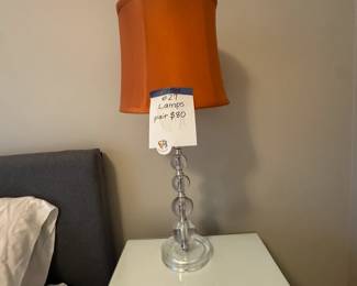 2 acrylic lamps with orange shades, sold as pair.