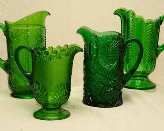 Antique EAPG pitchers including a U.S. Glass Co. tankard pitcher in California or Beaded Grape pattern #15059, emerald green, circa 1890s; A Westmoreland Shell and Jewel (Victor) green glass pitcher, circa 1892; vintage Fenton hobstar pinwheel green pitcher, vintage U.S. Glass Co. Florida pattern emerald green glass pitcher