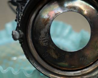 Close up of Another view of the antique 19th century blue opalescent ruffled glass brides bowl with silver plate frame, the frame showing repoussé designs and paw feet, and marked Quadruple Plate National S.W.