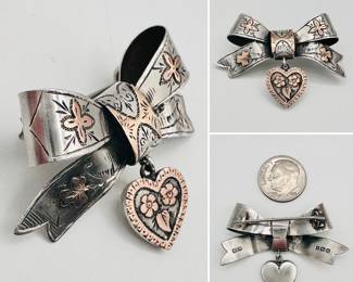 Antique English sterling silver and applied copper 'sweetheart' brooch, in a ribbon bow form with heart shaped pendant. Hallmarked WCM for silversmith William Clark Manton, Birmingham, England, with date stamp for 1905.