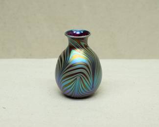 A Charles Lotton art glass vase, pulled feather design in rich iridescent colors; signed and dated 1987.
