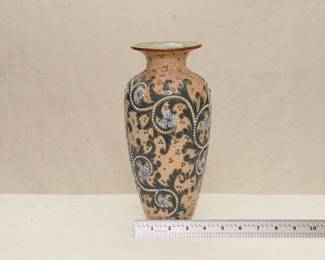 a late 19th Century Royal Doulton Lambeth stoneware vase by Doulton's master artist George Tinworth: Decorated with his signature "Seaweed Scroll" design, the beading to the scrolls ending in floret roundels on an amber ground