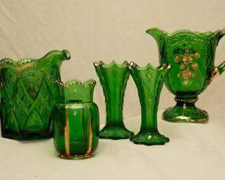 EAPG, art glass, and green! An antique Northwood Nearcut-Emerald pitcher, antique Riverside Glass Works X-Ray pattern emerald green and gold celery vase, a pair of Norwood emerald green glass tree trunk vases trimmed in gold, and a Northwood 'Flower Spray with Scrolls' or 'Intaglio' emerald green glass pitcher trimmed with gold