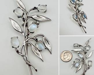 A Walter Lampl signed sterling silver, ruby, and moonstone brooch