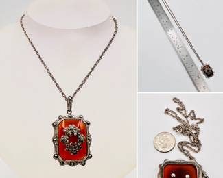 Art Deco 1920's sterling silver necklace, the pendant a carnelian agate stone in silver frame set with marcasite, the stone decorated with a silver and marcasite floral wreath