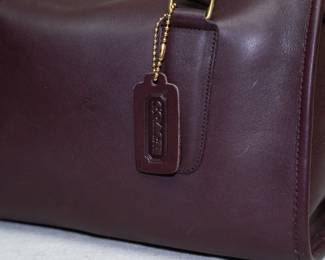 Closeup of the NWT new with tag Coach brand handbag, purchased at Marshall Field's. Deep coffee brown color, possibly the Madison Satchel model; interior stamped with No. 150-8615.