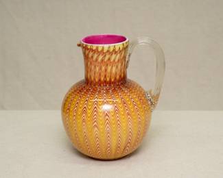 A breathtaking antique late 19th Century Stevens & Williams Glass 'Osiris' pulled design water pitcher, cased in clear crystal over a tonal red to pale amber pulled ground with pink interior, applied clear handle