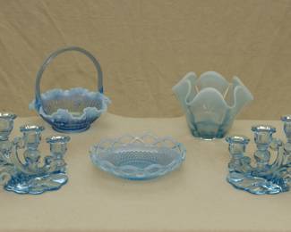 A vintage Fenton Art Glass blue opalescent cabbage rose basket, a Duncan Miller Canterbury blue opalescent vase / dish, a Fenton Art Glass blue opalescent Diamond & Lace glass bowl, and a pair of Summit Art Glass light blue candlesticks circa 1985, made using the Cambridge Caprice No. 1338 three-light candlesticks mold.