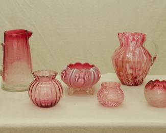 Art Glass including a vintage Peace & Happiness clear to cranberry pitcher with applied clear handle, a vintage cranberry glass ribbed art glass vase, a vintage Fenton Art Glass Rose Mist Vasa Murrhina pitcher with applied clear glass handle, a cranberry to clear rose bowl