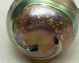 Closeup of a Charles Lotton Lava Cypriot art glass vase. Signed and dated 1989. Iridescent teal blue green gather over gold textured ground. Pinched rim.