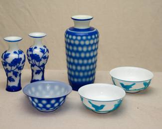 A pair of Chinese Peking Glass vases, carved blue overlay on white ground, decorated with flowering peonies; a pair of Chinese Peking Glass bowls, light blue carved overlay on white ground, decorated with birds perched on flowering plum branches; a Chinese Peking glass vase and bowl, both with blue overlay cut to reveal a white dot pattern.
