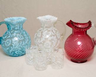 Vintage Fenton art glass: a light blue colored Daisy and Fern pattern Pitcher, and a Fenton clear with white Daisy and Fern pattern pitcher with 4 tumblers, circa 1940s-50s, and a 20th century Fenton cranberry glass pitcher with swirled optic pattern, crimped flared rim and applied clear glass handle