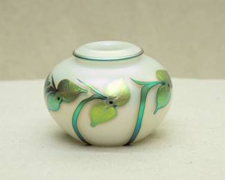 A charming art glass vase by renowned glass artist Charles Lotton, white opal glass vase with rolled lip and iridescent green flowers design, signed and dated 1993
