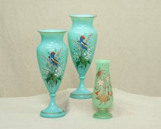 A beautiful pair of vintage uranium glass opaline vases in robin's egg blue, hand painted with birds and flowers with gilt accents, and a smaller opaline green uranium glass vase hand painted with flowers and gilt accents. All three are likely Bohemian art glass by Harrach late 1880s.