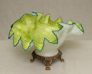 An amazing vintage cased glass bridal bowl or bon bon dish on an ormolu paw footed base. The cased glass opalescent white with interior of bright celery green optic coin dots, crimped and ruffled rim edged with a dark teal blue green. Masterfully crafted!