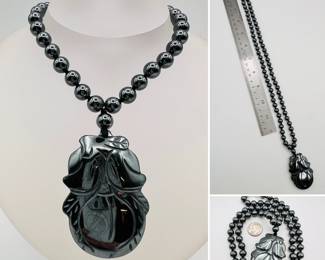 Polished natural black stone bead and carved pendant necklace