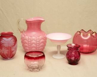 A Thomas Webb & Sons gem cameo glass vase, delicate palm frond design over cranberry glass, circa 1900, art nouveau, Stourbridge, England; a Consolidated Glass Co. Guttate pattern pink EAPG art glass pitcher, a small Rubina glass optic hand blown glass footed bowl, a peach blow matte/satin art glass compote, a vintage Pilgrim Glass MCM cranberry optic bud vase, hand blown, applied clear glass rigaree collar, ruffled rim; a possibly Mont Joye or Moser French Bohemian art glass ribbed raspberry pink with gold enameling rose bowl, Art Nouveau, late 1800s/early 1900s.