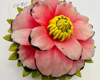 Closeup view of the colorful and detailed hand-painted floral (camellia) brooch from Coro